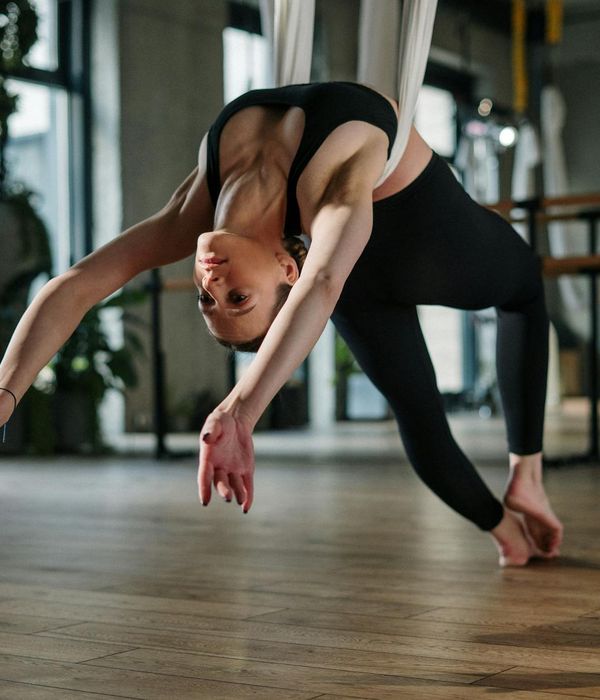 Woman performing a graceful warrior yoga pose, highlighting flexibility and strength.